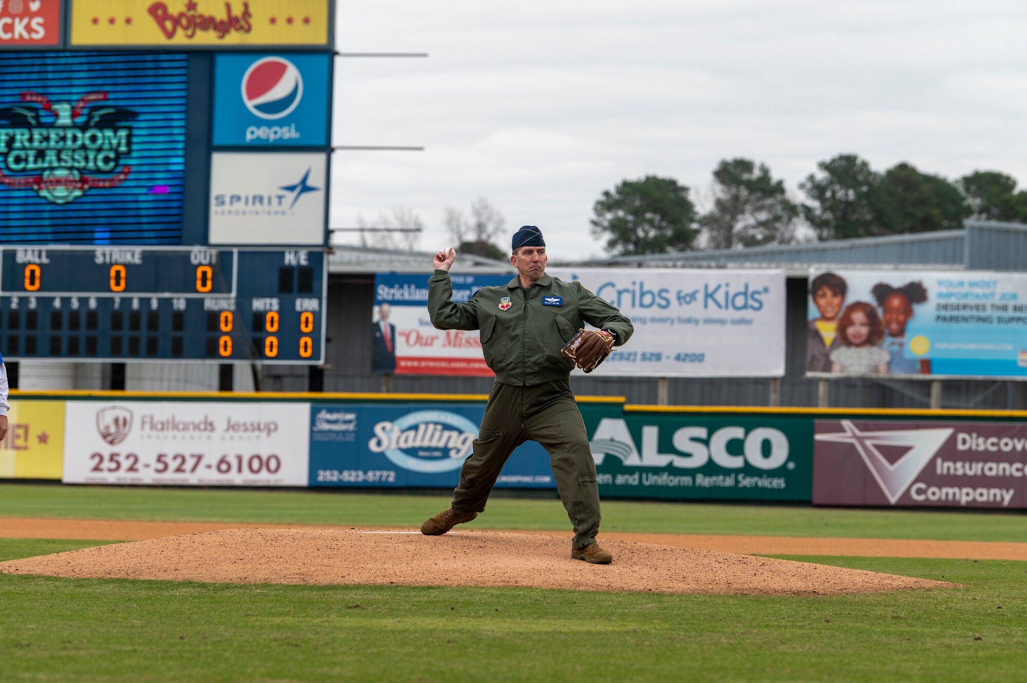 Col. Bryce Silver, 4th Fighter Wing vice commander, throws the first pitch during the 12th Annual Freedom Classic baseball series at Grainger Stadium in Kinston, North Carolina, Feb. 26, 2022. The first pitch is a long-standing tradition of baseball, in which a guest of honor throws a ball to mark the end of pregame festivities and the start of the game. (U.S. Air Force photo by Airman 1st Class Kevin Holloway)