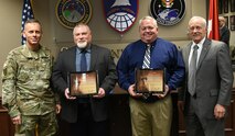 Lt. Gen. Daniel L. Karbler, left, commanding general of U.S. Army Space and Missile Defense Command; and Richard P. De Fatta, right, Deputy to the USASMDC Commander, present Arthur A. Lampert, center left, security specialist with the SMDC G34 Protection Division; and Steven D. Moseley, center right, facility operations manager with the SMDC Deputy Chief of Staff, Engineer Construction Division; with a Director of Army Safety Risk Management Safety Award during a ceremony, March 3, at SMDC’s headquarters on Redstone Arsenal. (U.S. Army photo by Jason B. Cutshaw)