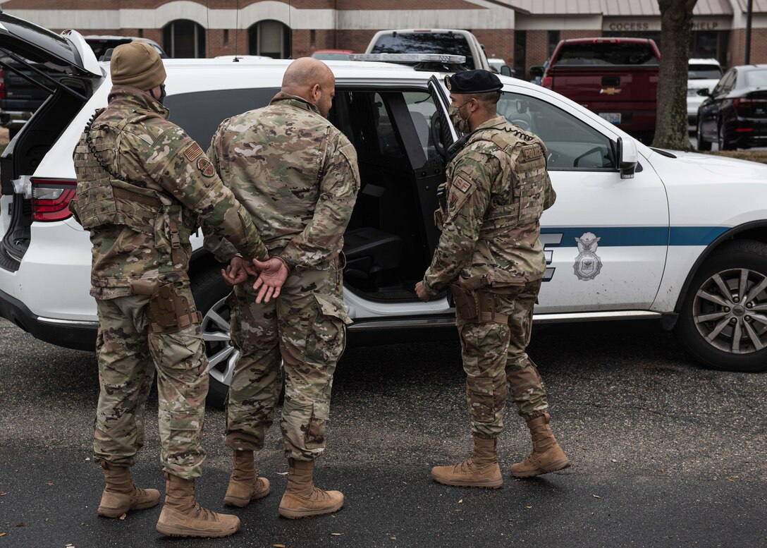 Airmen with the 633d Security Forces Squadron arrest a simulated combatant during a mock gate runner exercise at Joint Base Langley-Eustis, Va., Feb. 25, 2022.