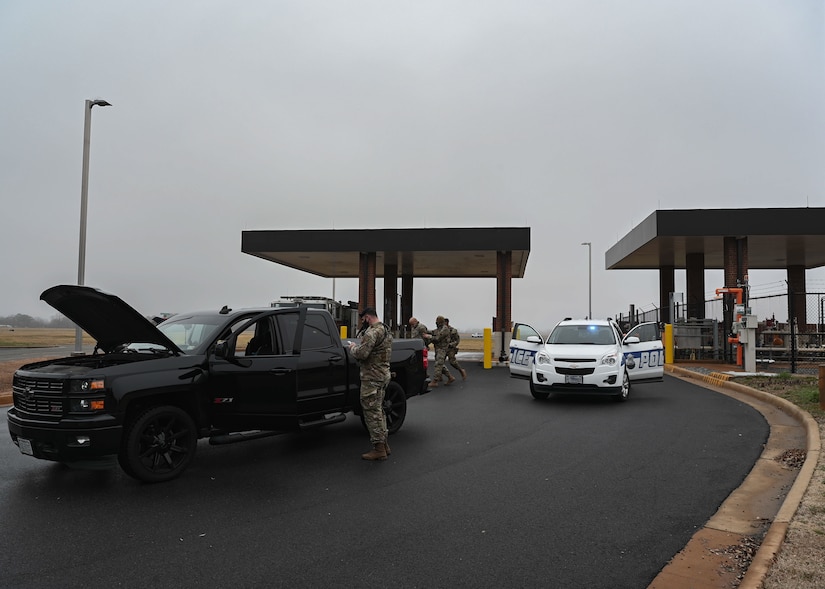 U.S. Airmen from the 633d Security Forces Squadron inspect a vehicle during a mock gate runner exercise at Joint Base Langley-Eustis, Va., Feb. 25, 2022.