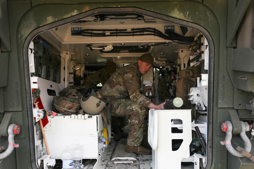 A soldier works inside a military vehicle