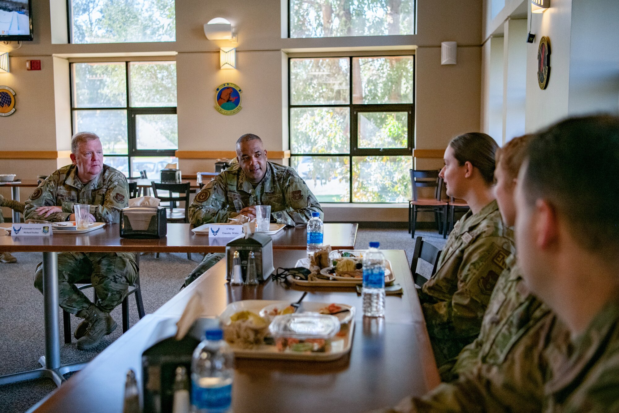 Lt. Gen. Richard W. Scobee, chief of the Air Force Reserve and commander of the Air Force Reserve Command, and Chief Master Sgt. Timothy C. White Jr., senior enlisted advisor to the Chief of Air Force Reserve and command chief of Air Force Reserve Command, have lunch with Airmen at the Monarch Dining Facility at Travis Air Force Base, California, Feb. 12, 2022. The opportunity allowed the 349th Air Mobility Wing to showcase its people, mission, accomplishments, and innovation efforts. (U.S. Air Force photo by Senior Airman Brady Penn)