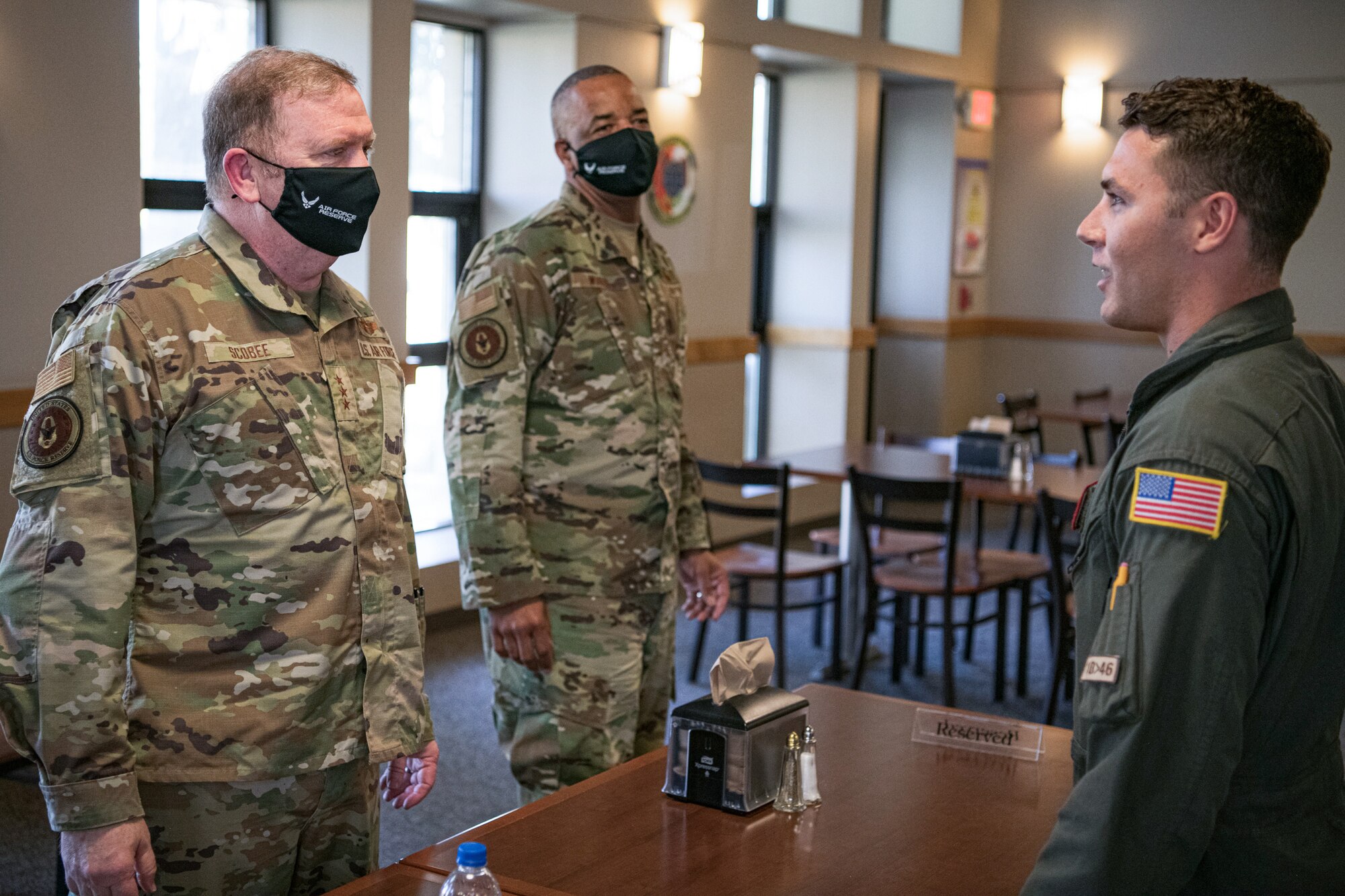 Lt. Gen. Richard W. Scobee, chief of the Air Force Reserve and commander of the Air Force Reserve Command, and Chief Master Sgt. Timothy C. White Jr., senior enlisted advisor to the Chief of Air Force Reserve and command chief of Air Force Reserve Command, have lunch with Airmen at the Monarch Dining Facility at Travis Air Force Base, California, Feb. 12, 2022. The opportunity allowed the 349th Air Mobility Wing to showcase its people, mission, accomplishments, and innovation efforts. (U.S. Air Force photo by Senior Airman Brady Penn)