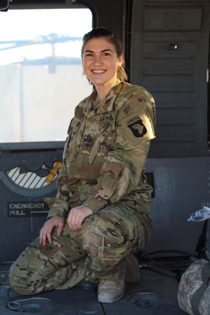 U.S. Army Staff Sgt. Claire Johnson, a combat medic assigned to Charlie Company, 3rd Battalion, 126th Aviation Regiment, Vermont National Guard, sits in the cabin of a UH-60 Black Hawk helicopter. (U.S. Army National Guard photo by Joshua Cohen)