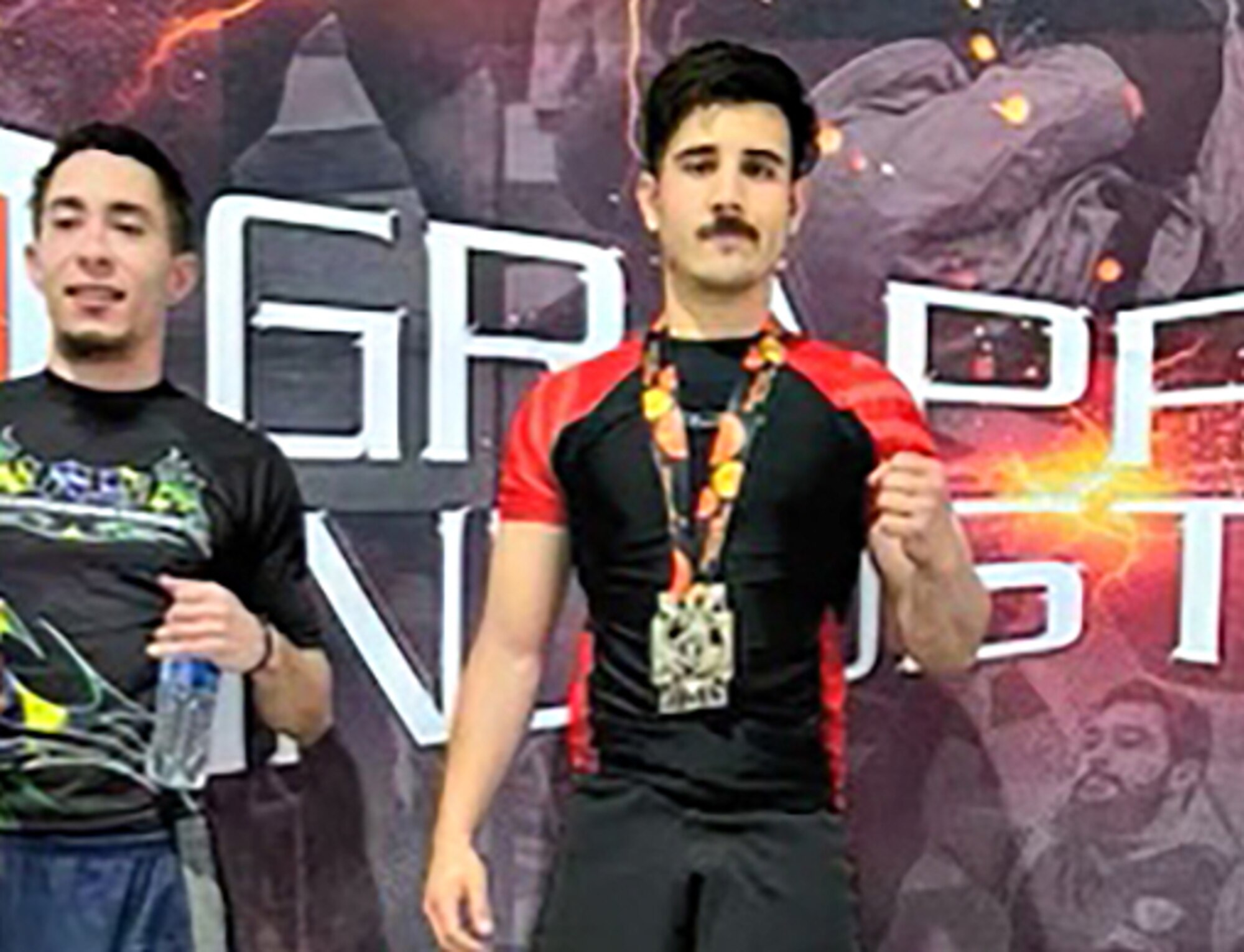 A man is standing on an awards podium.