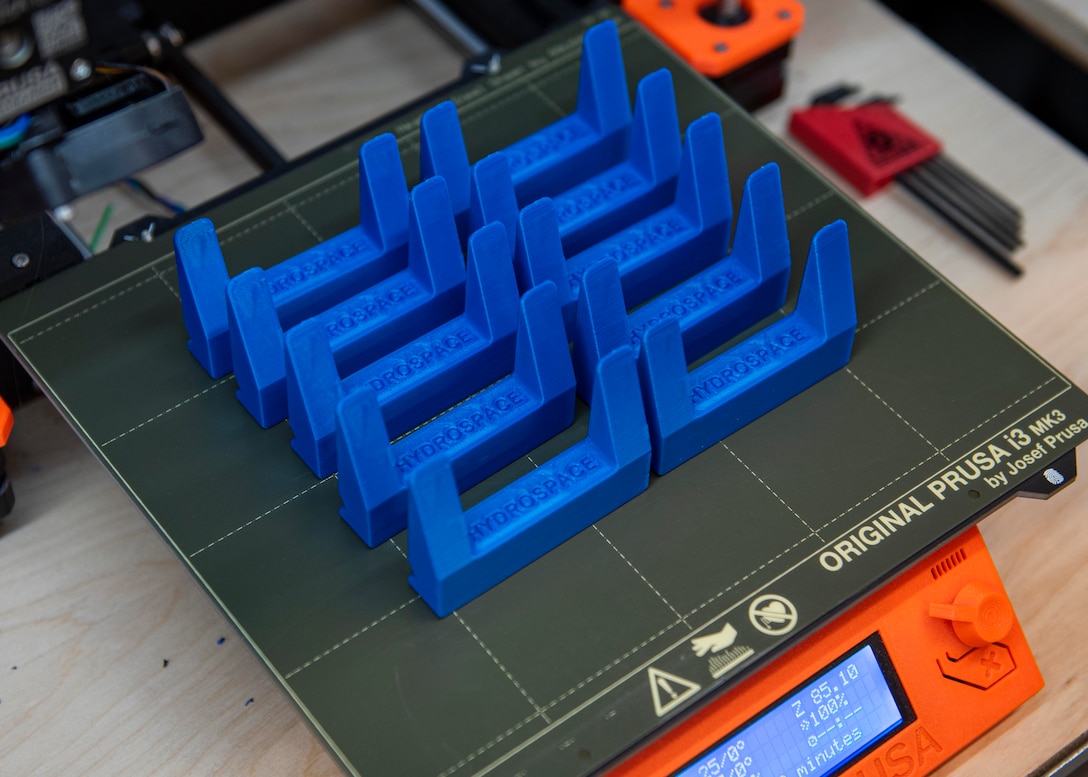 A 3-D printed Laptop Lifter (aka the Tide Riser) close to completion. Naval Surface Warfare Center Panama City Division's Codes E15 Hydrospace Laboratory and E42 Additive Manufacturing Lab (AML) collaborated to produce this solution to help improve ventilation to the division's new computers to keep them from overheating due to prolonged use. Data obtained using Forward-Looking Infra-Red (FLIR) technology measured a 15-20% reduction in temperature from the hottest regions of the laptops. (U.S. Navy photo by Eddie Green)
