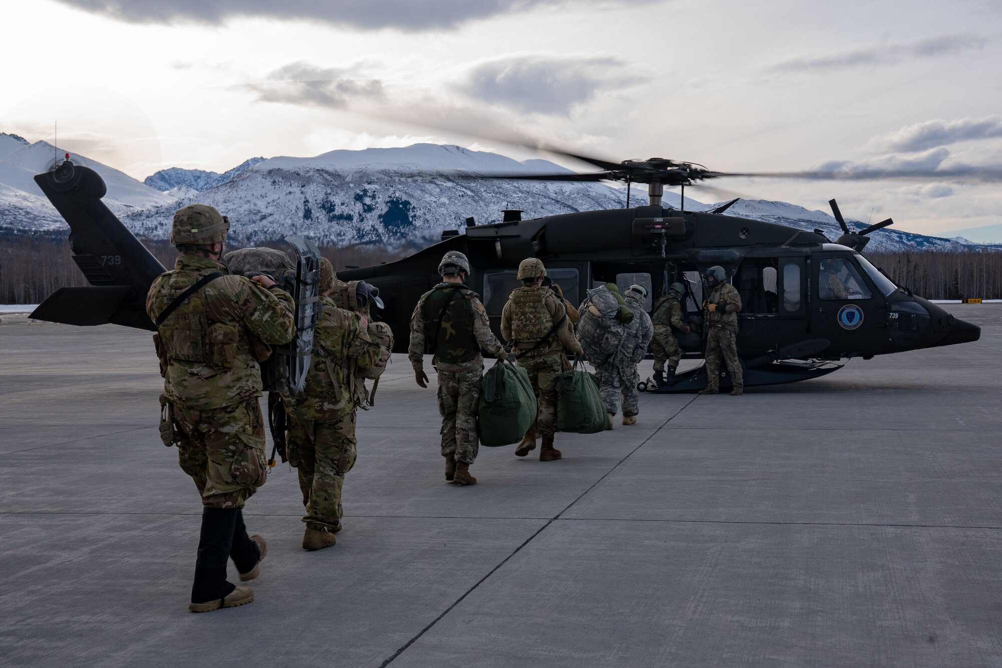 Guardsmen and Airmen board a UH-60 Blackhawk.