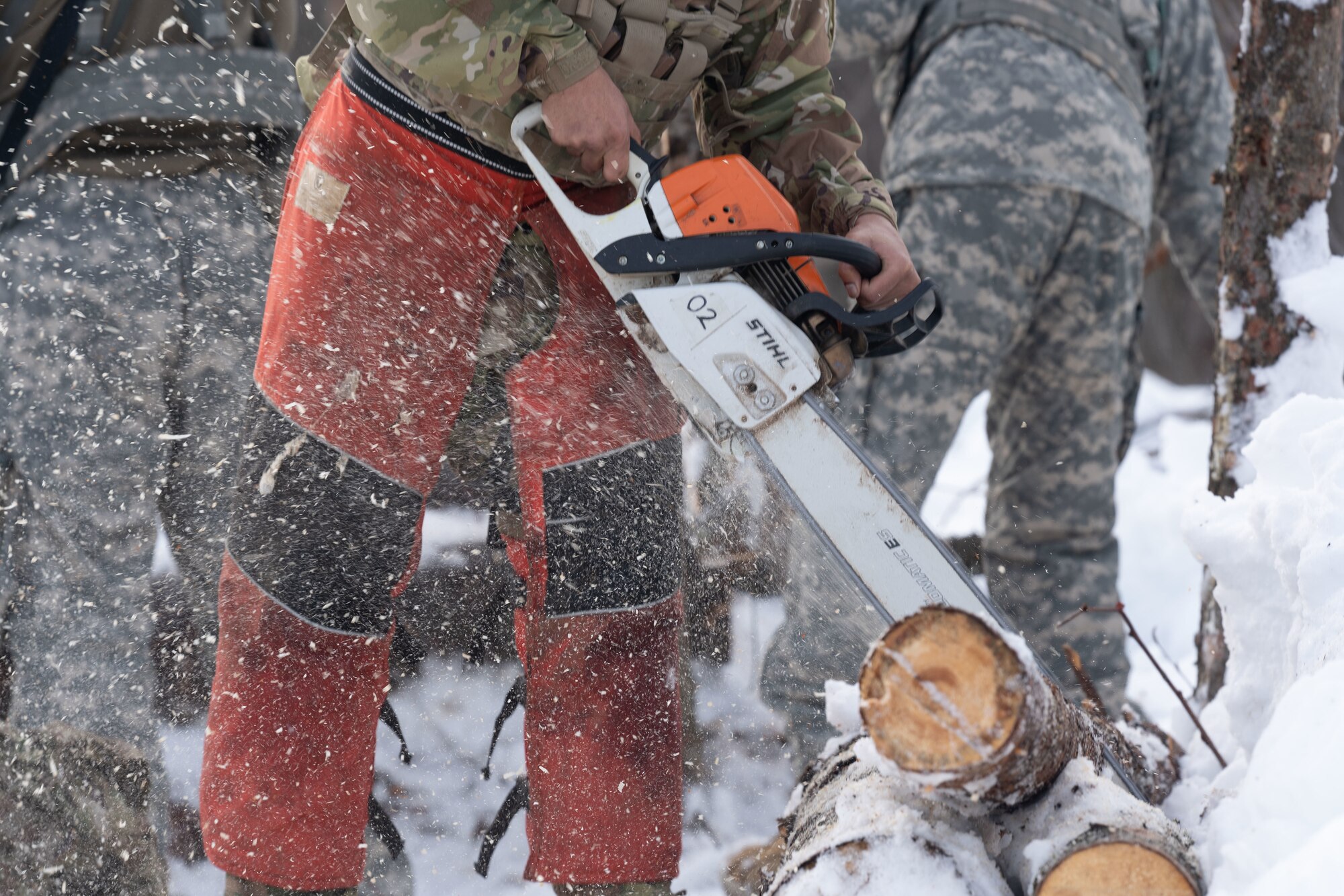 A guardsman constructs an arctic defensive fighting position during a joint operations field training exercise at Camp Mad Bull.