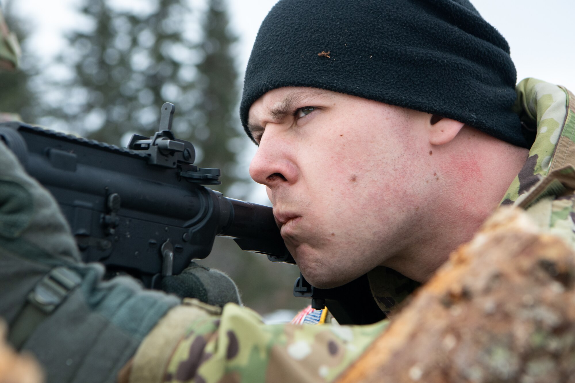 A guardsmen defends an arctic fighting position during a joint operations field training exercise at Camp Mad Bull.