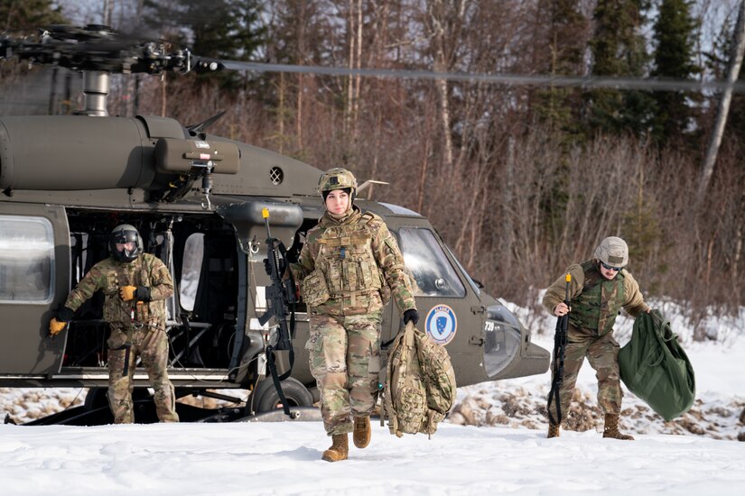 Staff Sgt. Amanda Kopecky returns from an Alaska Army National Guard UH-60 Blackhawk .