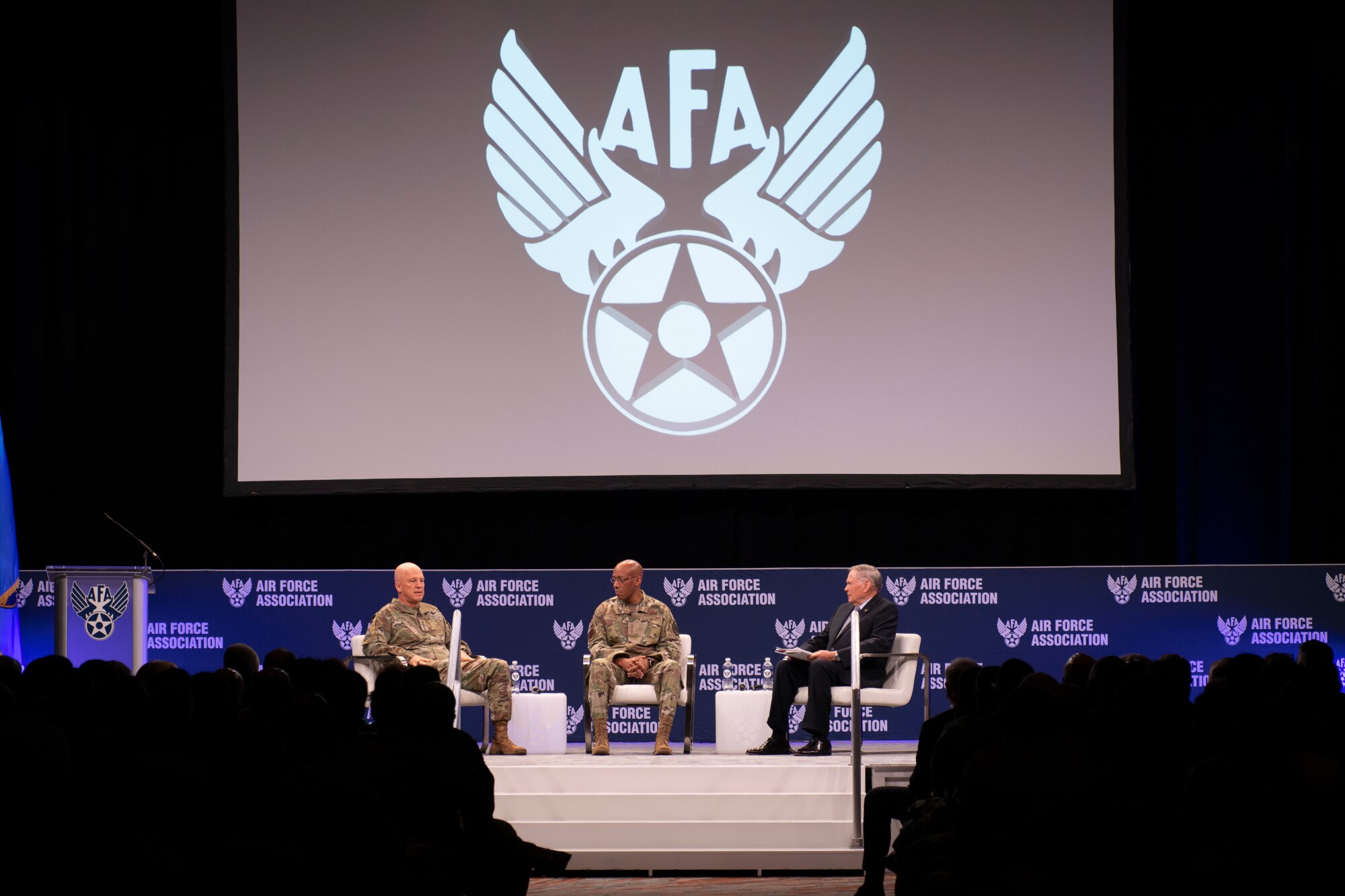 Chief of Space Operations Gen. John W. “Jay” Raymond, left, and Chief of Staff of the Air Force Gen. CQ Brown, Jr., center, participate in a fireside chat during the Air Force Association’s Air Warfare Symposium in Orlando, Fla., March 3, 2022. Brown and Raymond discussed the role Airmen and Guardians play in the pacing challenge and force modernization. (U.S. Air Force photo by Staff Sgt. Elora J. McCutcheon)