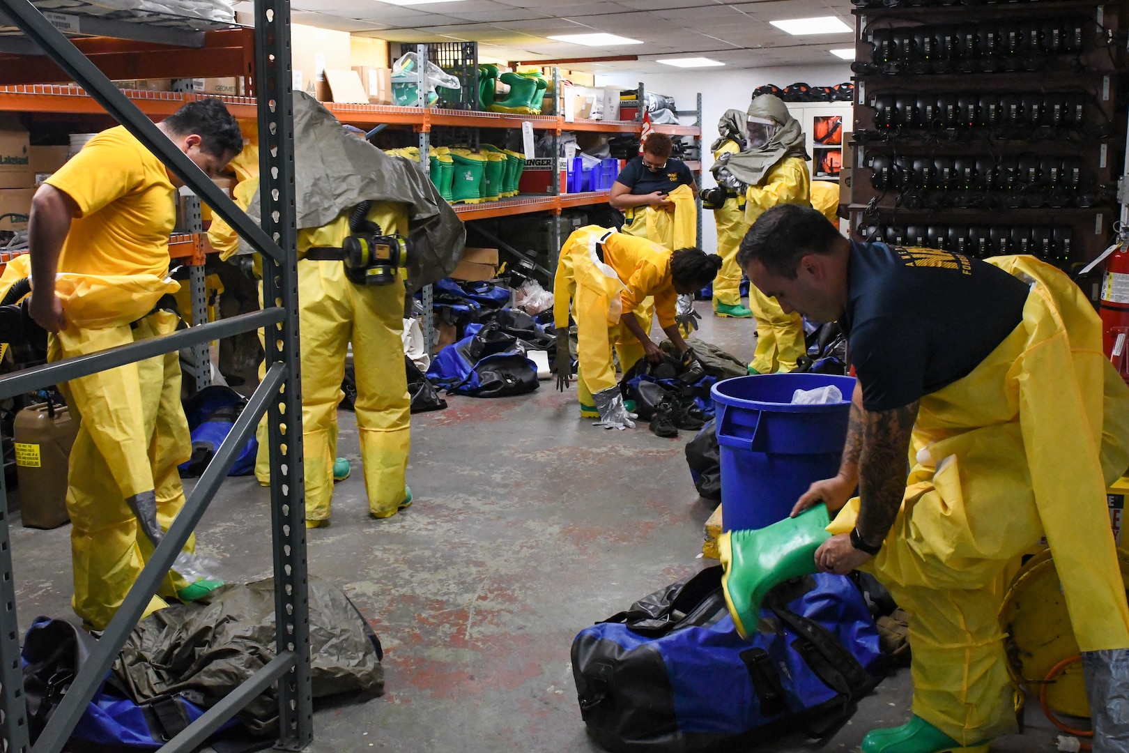 Sailors in hazmat gear complete outdoor training.