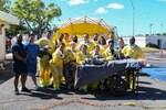 Sailors in hazmat gear complete outdoor training.