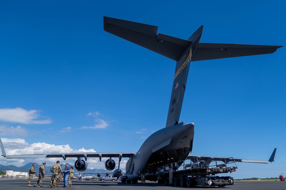 Members from the 15th Wing inspection team watch a cargo load during Exercise TROPIC FURY at Joint Base Pearl Harbor-Hickam, Hawaii, March 2, 2022. TROPIC FURY is a base-wide readiness exercise which evaluates Airmen’s readiness and ability to execute and sustain rapid global mobility around the Indo-Pacific and the globe. (U.S. Air Force photo by Airman 1st Class Makensie Cooper)