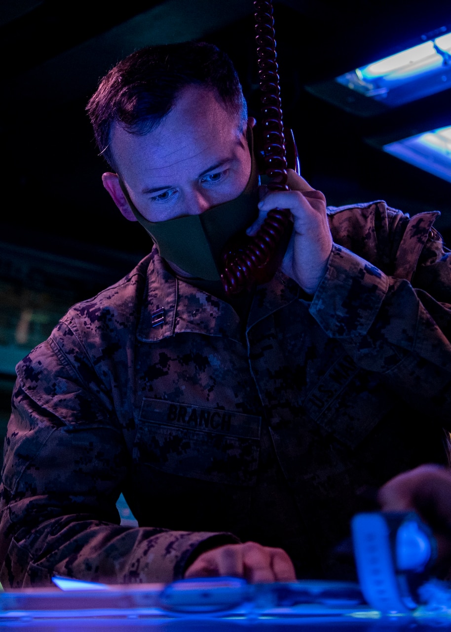 PACIFIC OCEAN (March 1, 2022) U.S. Marine Capt. Austin Branch, from Coronado, California, assigned to the U.S. Marine Corps Fifth Air Naval Gun Liaison Company (5th ANGLICO), simulates Naval Surface Fire Support (NSFS) with the Japanese Ground Self-Defense Force (JGSDF) in the Combat Information Center aboard the Arleigh Burke-class guided-missile destroyer USS Dewey (DDG 105) while participating in bilateral advanced warfare training (BAWT). BAWT is an annual bilateral training exercise that improves the partnership between U.S. and Japanese Forces. This year’s exercise focused on enhancing readiness and interoperability of coalition forces from the U.S. and Japan Maritime Self-Defense Force. (U.S. Navy photo by Mass Communication Specialist 1st Class Benjamin Lewis)