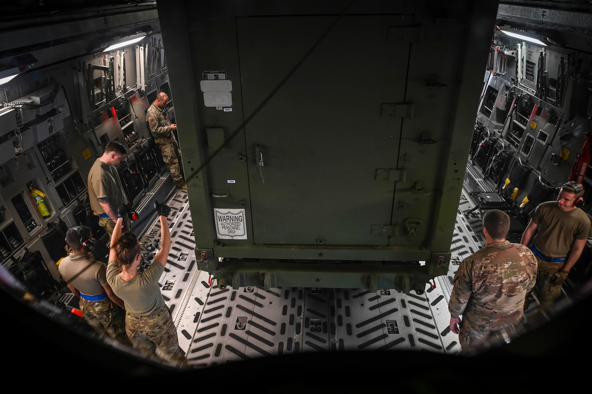 U.S. Air Force Airmen from Joint Base Elmendorf-Richardson, Alaska, and Joint Base Pearl Harbor-Hickam, Hawaii, load the Terminal High-Altitude Area Defense, assigned to Task Force Talon, equipment onto a C-17 Globemaster III during Operation Talon Lightning on Andersen Air Force Base, Guam, March 4, 2022.
