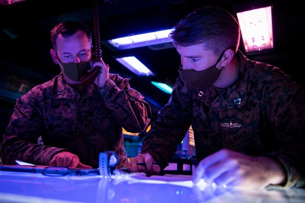 PACIFIC OCEAN (March 1, 2022) U.S. Marine Capt. Austin Branch, left, from Coronado, California, and U.S. Navy Lt. Dillon Duke, from Edmond, Oklahoma, both assigned to the U.S. Marine Corps Fifth Air Naval Gun Liaison Company (5th ANGLICO), conduct  Naval Surface Fire Support (NSFS) communication drills with the Japanese Ground Self-Defense Force (JGSDF) in the Combat Information Center aboard the Arleigh Burke-class guided-missile destroyer USS Dewey (DDG 105) while participating in bilateral advanced warfare training (BAWT). BAWT is an annual bilateral training exercise that improves the partnership between U.S. and Japanese Forces. This year’s exercise focused on enhancing readiness and interoperability of coalition forces from the U.S. and Japan Maritime Self-Defense Force. (U.S. Navy photo by Mass Communication Specialist 1st Class Benjamin Lewis)