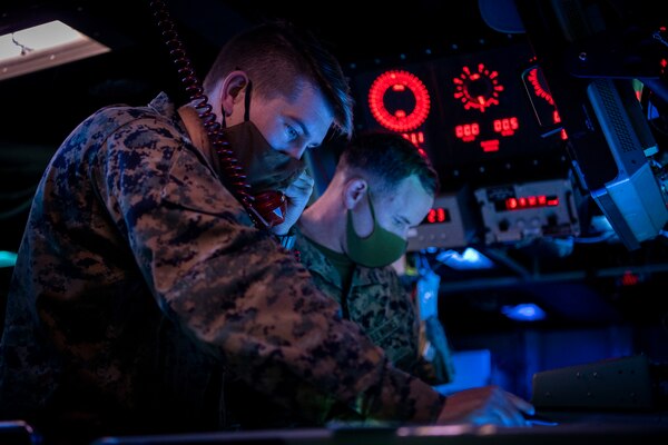 PACIFIC OCEAN (March 1, 2022) U.S. Navy Lt. Dillon Duke, left, from Edmond, Oklahoma, and U.S. Marine Capt. Austin Branch, from Coronado, California, both assigned to the U.S. Marine Corps Fifth Air Naval Gun Liaison Company (5th ANGLICO), simulate Naval Surface Fire Support (NSFS) with the Japanese Ground Self-Defense Force (JGSDF) in the Combat Information Center aboard the Arleigh Burke-class guided-missile destroyer USS Dewey (DDG 105) while participating in bilateral advanced warfare training (BAWT). BAWT is an annual bilateral training exercise that improves the partnership between U.S. and Japanese Forces. This year’s exercise focused on enhancing readiness and interoperability of coalition forces from the U.S. and Japan Maritime Self-Defense Force. (U.S. Navy photo by Mass Communication Specialist 1st Class Benjamin Lewis)
