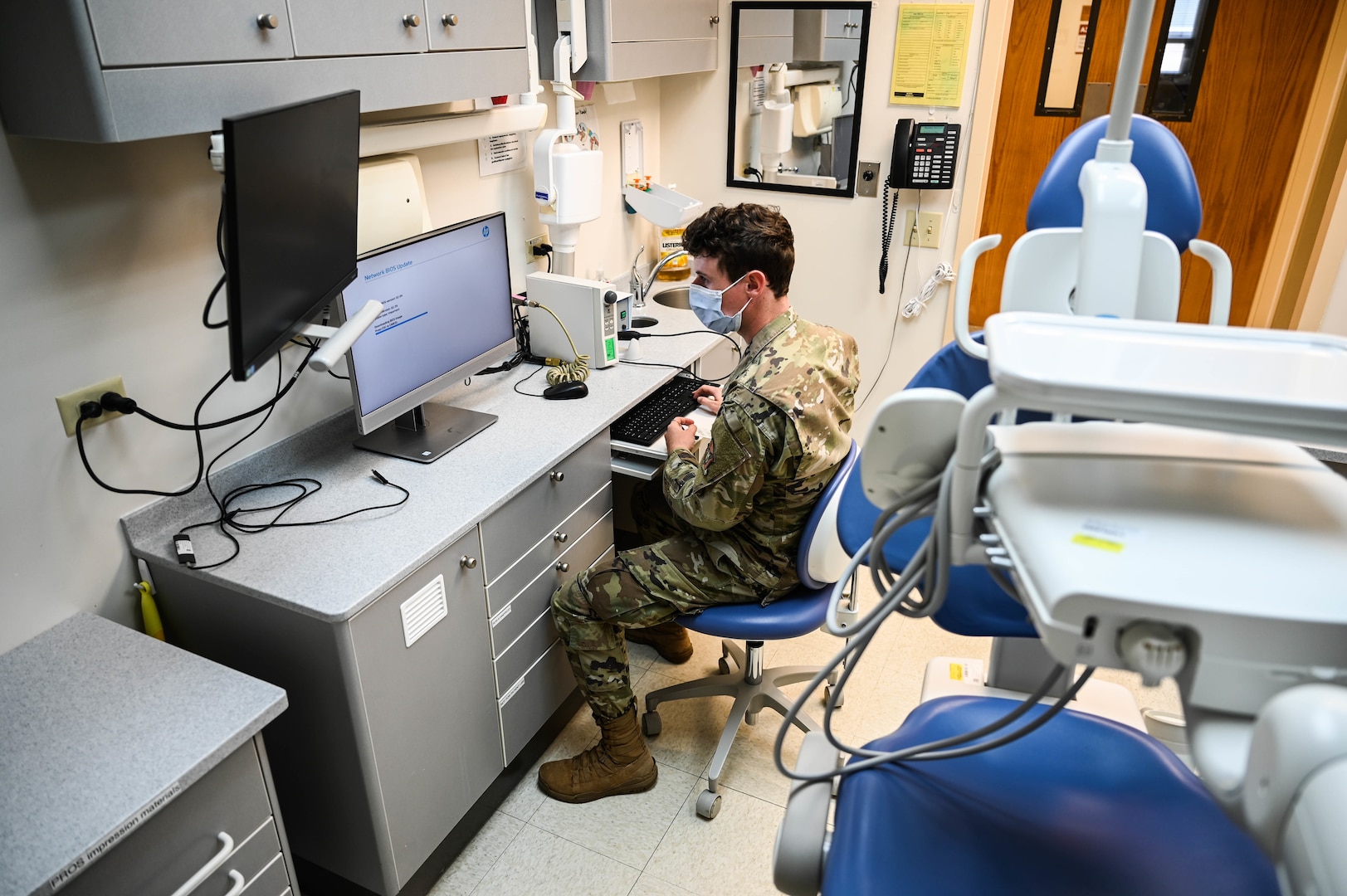 Airman 1st Class Paul Hasler, 15th Medical Group Medical Information Systems Flight technician, reimages a medical workstation in the dental clinic at Joint Base Pearl Harbor-Hickam, Hawaii, Feb. 24, 2022. The flight configured, deployed and tested more than 200 new pieces of hardware for Medical Healthcare System Genesis, which was brought online Sept. 25, 2021. (U.S. Air Force photo by Staff Sgt. Alan Ricker)