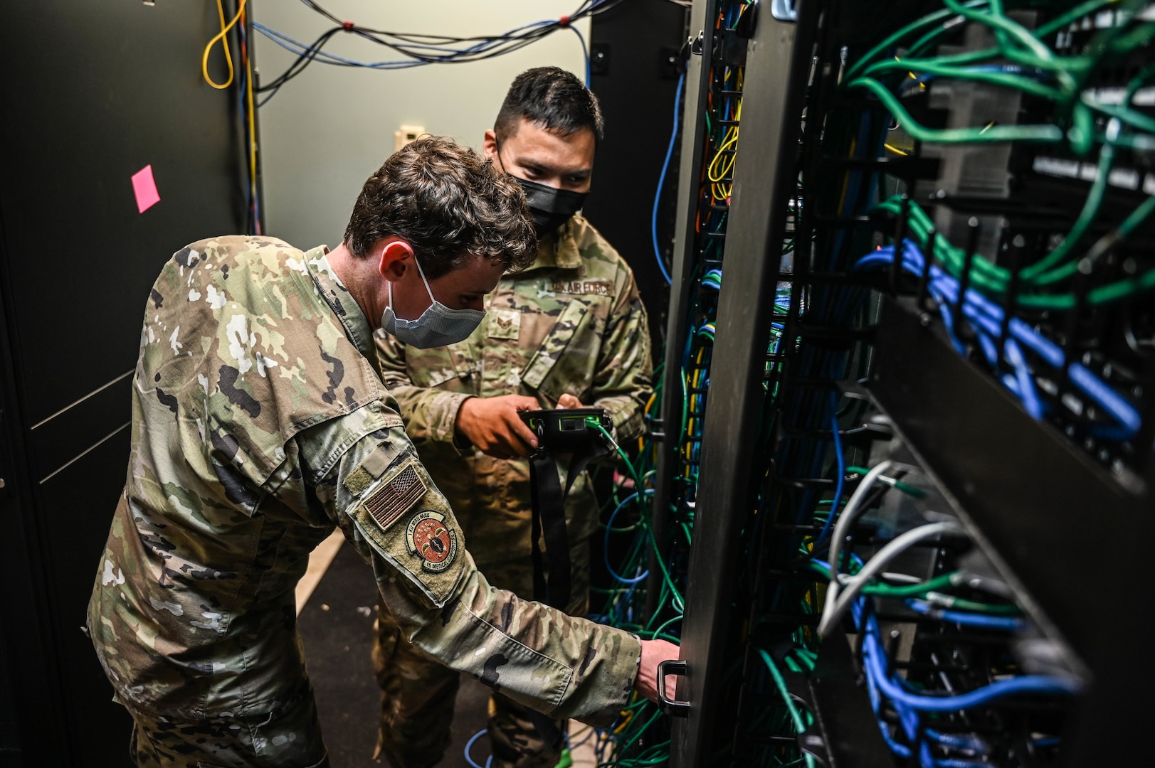 Airman 1st Class Paul Hasler (left), 15th Medical Group Medical Information Systems Flight technician, and Staff Sgt. Deangelo Johnson (right), 15th MDG MIS noncommissioned officer in-charge, test network port activations at Joint Base Pearl Harbor-Hickam, Hawaii, Feb. 24, 2022. The flight manages a $1.7 million network and sustains nearly $650,000 worth of equipment, maintaining readiness and care for Air Force personnel in Hawai’i. (U.S. Air Force photo by Staff Sgt. Alan Ricker)