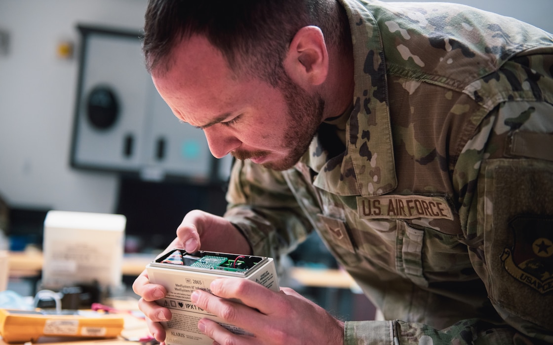 Airman repairs medical equipment.