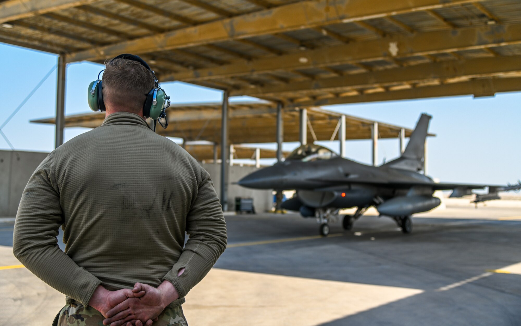 U.S. Air Force Airman 1st Class Trace Cannon, 378th Expeditionary Maintenance Squadron crew chief, conducts pre-flight checks for an F-16 Fighting Falcon at King Abdulaziz Air Base, Kingdom of Saudi Arabia, Feb. 13, 2022. Training with partner nations strengthens military-to-military relationships, improves interoperability and promotes regional stability. (U.S. Air Force photo by Staff Sgt. Christina A. Graves)