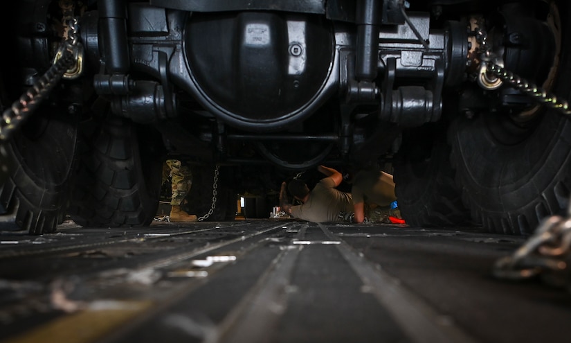 U.S. Air Force Senior Airman Oak Lineberry, air transportation technician assigned to the 734th Air Mobility Squadron, secures a trailer onto a C-17 Globemaster III during Operation Talon Lightning on Andersen Air Force Base, Guam, March 4, 2022.