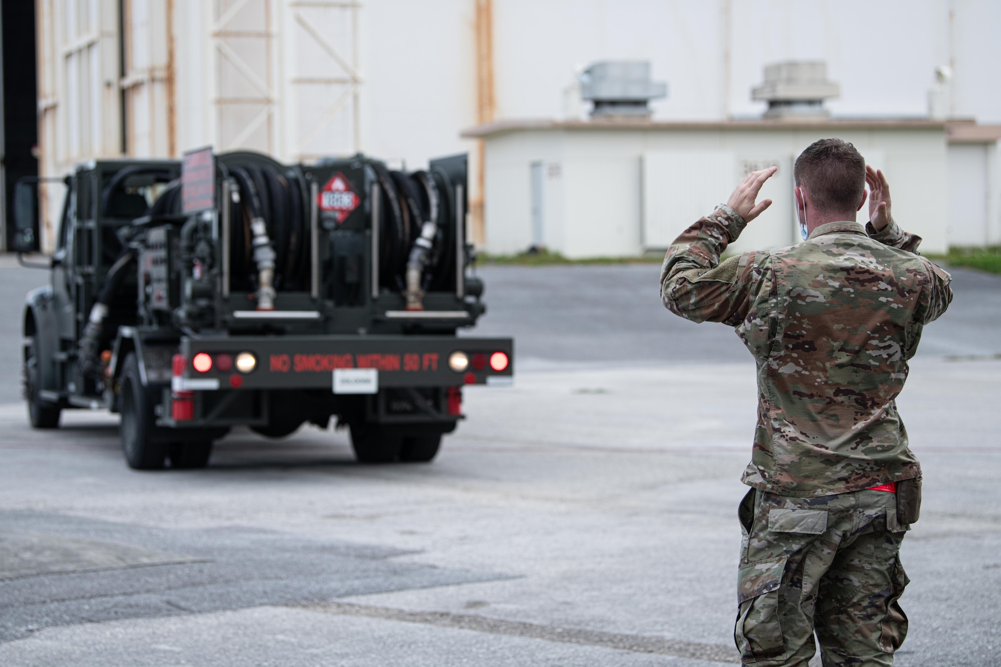 Airmen directs a fuels truck.