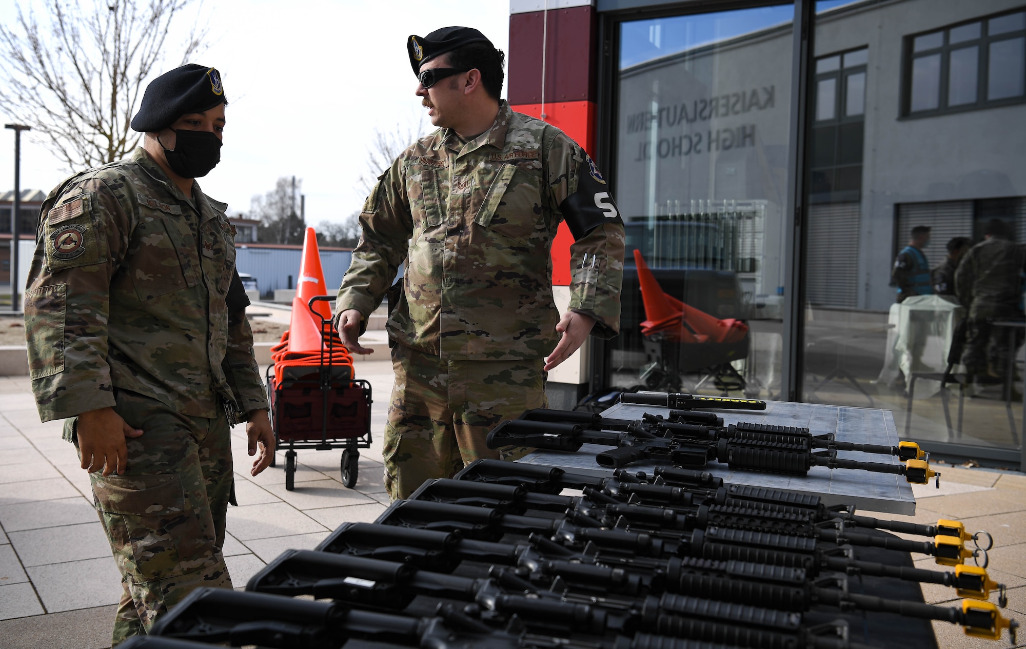 U.S. Air Force Tech. Sgt. Cameron Husted, 569th United States Forces Police Squadron noncommissioned officer in charge of combat arms, right, and Staff Sgt. Mark Nelson, 569 USFPS combat arms instructor, discuss exercise Operation Varsity 22-1 at Vogelweh Air Base, Germany, March 1, 2022. This exercise simulated an active shooter threat in order to test the capabilities of first responders to react under such circumstances. (U.S. Air Force photo by Airman 1st Class Jared Lovett)