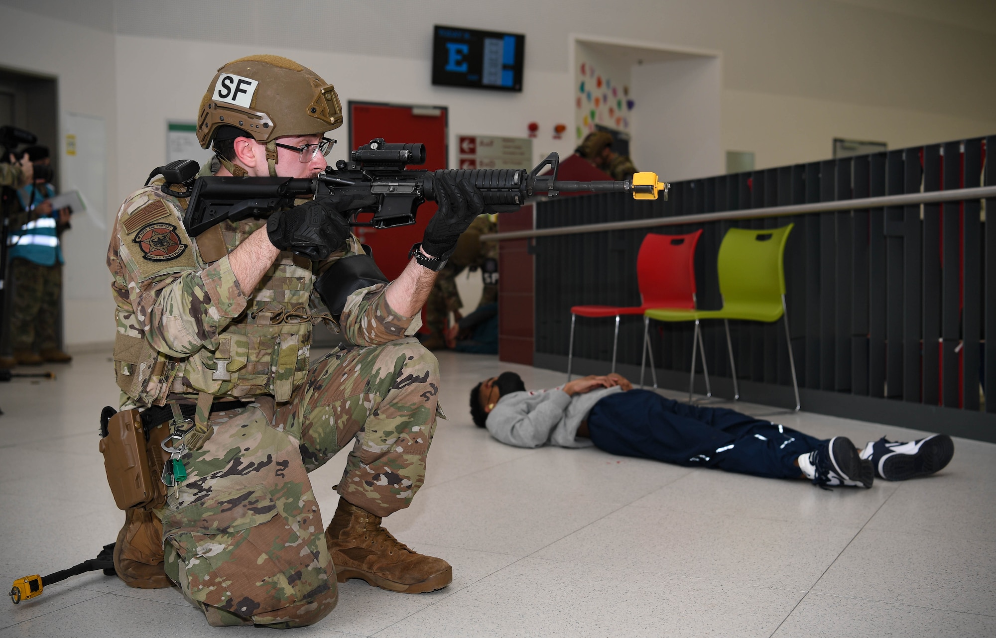 U.S. Air Force Senior Airman Willian Rhea, 569th United States Forces Police Squadron patrolman, neutralizes a simulated active shooter threat during exercise Operation Varsity 22-1 at Kaiserslautern High School at Vogelweh Air Base, Germany, March 1, 2022. Wing inspection team members followed Airmen from various groups to collect data on how they react to every situation they encounter and to take note on whether or not they followed proper procedures. (U.S. Air Force photo by Airman 1st Class Jared Lovett)