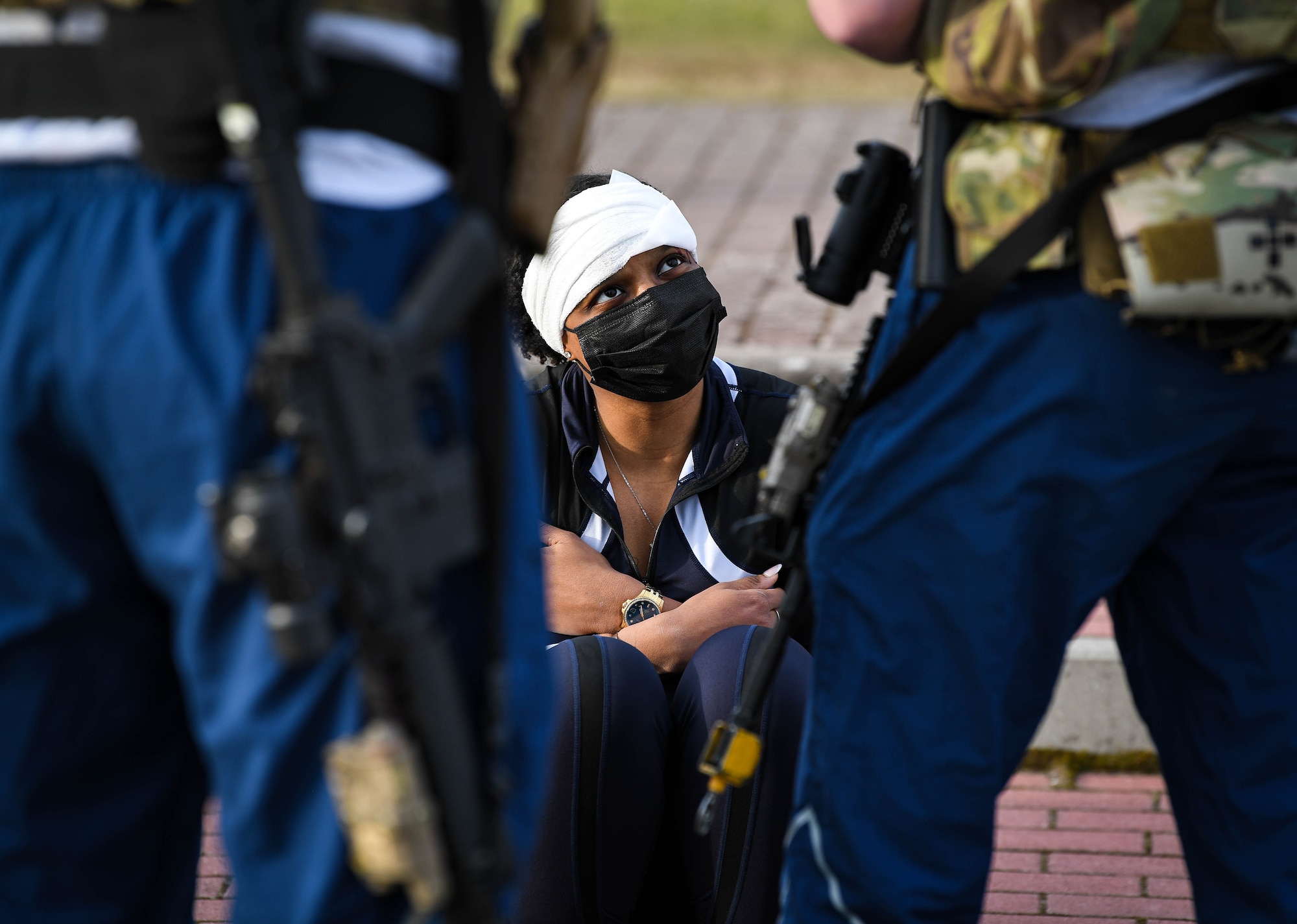 U.S. Air Force Staff Sgt. Mikayla Mohead, 86th Medical Support Squadron noncommissioned officer in charge of personnel administration, acts as a casualty during exercise Operation Varsity 22-1 at Kaiserslautern High School at Vogelweh Air Base, Germany, March 1, 2022. Wing inspection team members followed Airmen from various groups to collect data on whether or not they followed proper procedures and provided casualties with the care they needed. (U.S. Air Force photo by Airman 1st Class Jared Lovett)