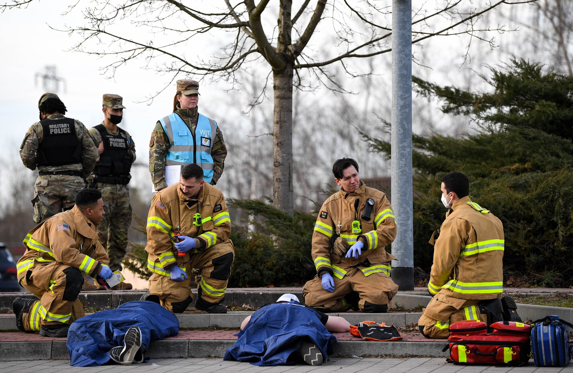 Airmen assigned to the Kaiserslautern Military Community participate in an active shooter readiness exercise during exercise Operation Varsity 22-1 at Vogelweh Air Base, Germany, March 1, 2022. Wing inspection team members followed Airmen from various groups to collect data on whether or not they followed proper procedures and provided casualties with the care they needed. (U.S. Air Force photo by Airman 1st Class Jared Lovett)