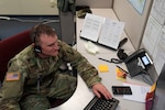Staff Sgt. Steven San Antonio of the 195th Regional Training Institute answers a call Feb. 14, 2022, at the St. Joseph COVID triage call center in Nashua, New Hampshire. San Antonio is one of two New Hampshire Guardsmen assigned to the center as part of Operation Winter Surge.