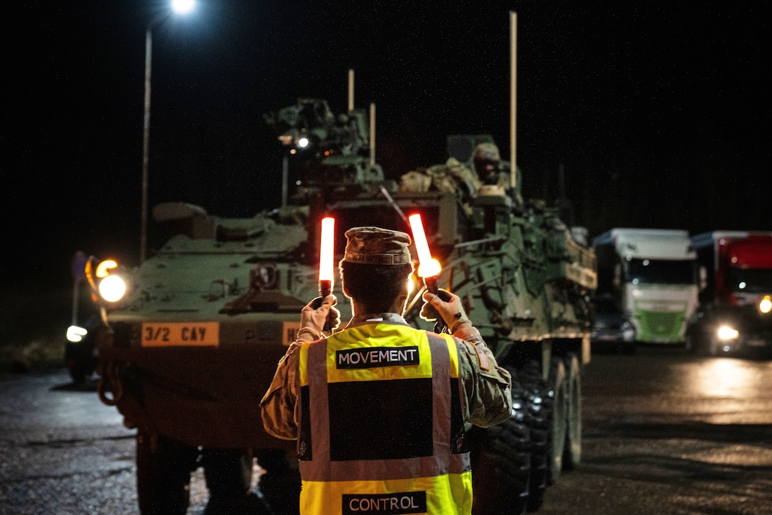 Vehicles stop after crossing into the Latvian border during a tactical road march.