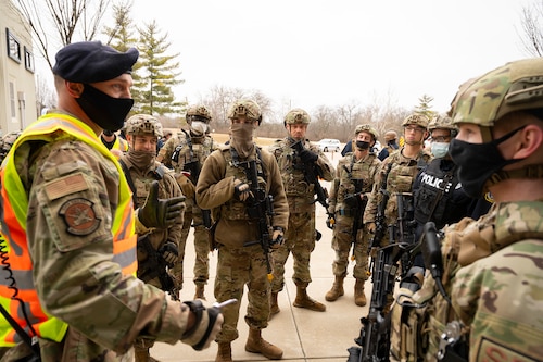A member of the 88th Air Base Wing’s inspection team (left) speaks with 88th Security Forces Squadron Defenders at the end of an active-shooter exercise Feb. 23, 2022, at Wright-Patterson Air Force Base, Ohio. The exercise gave first responders, including police, fire and medical personnel, the opportunity to practice coordinating emergency actions and procedures. (U.S. Air Force photo by R.J. Oriez)