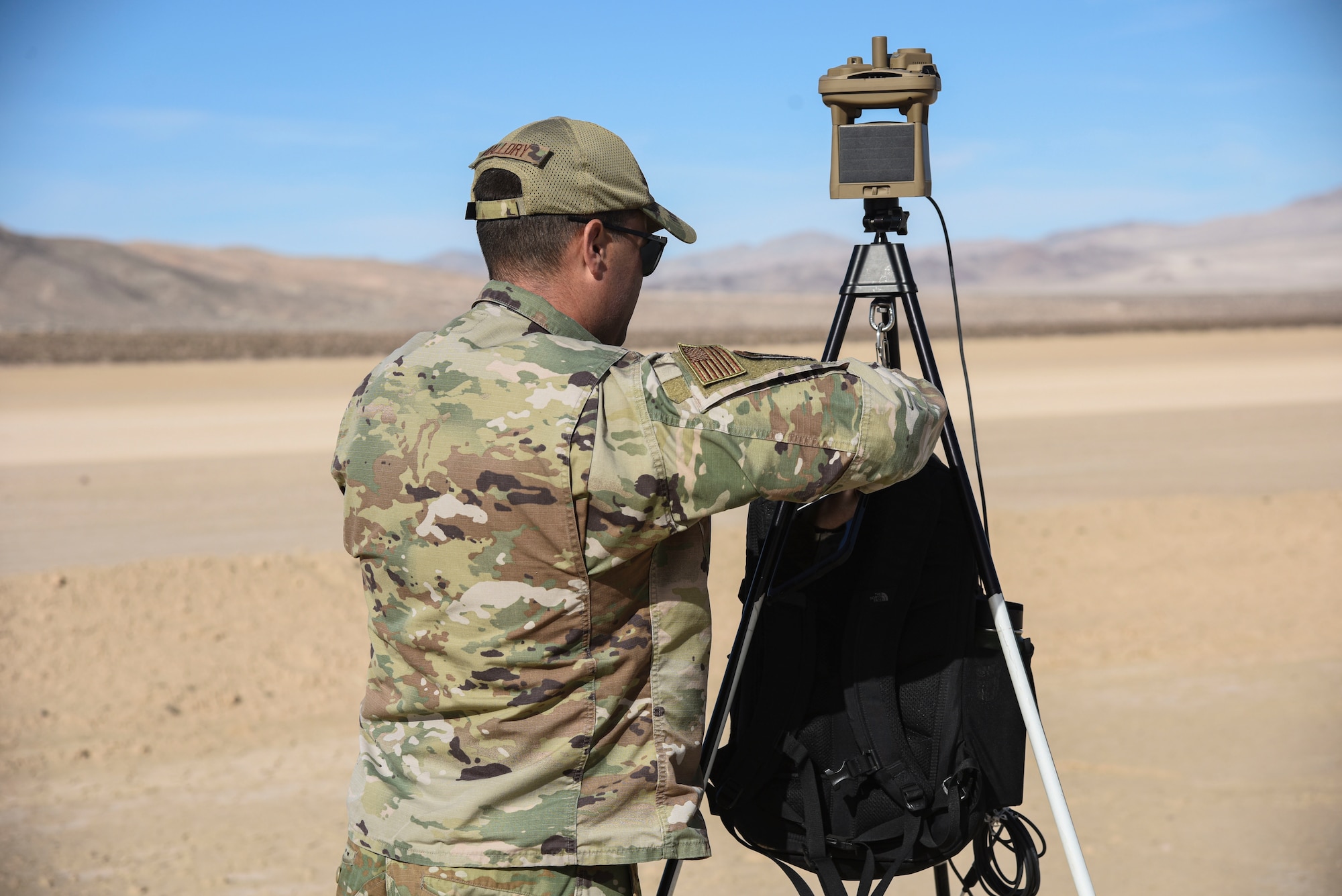 A photo of an Airmen setting up weather equipment.