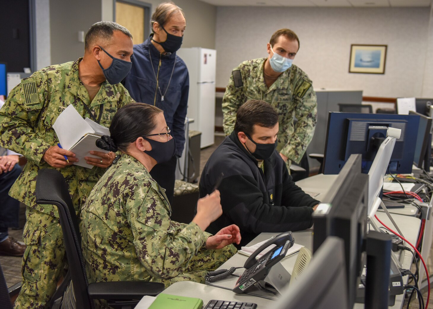 Navy Reserve Sailors and a civilian assigned to the maritime space cyber fires and effects coordination cell during Exercise Keen Edge 22 participate in a non-kinetic operations meeting the Fleet Cyber Command/U.S. 10th Fleet situation room. Keen Edge is a bilateral command post exercise conducted to increase combat readiness and synchronization between the U.S. and Japan. (U.S. Navy photo by Mass Communication Specialist 2nd Class William Sykes)