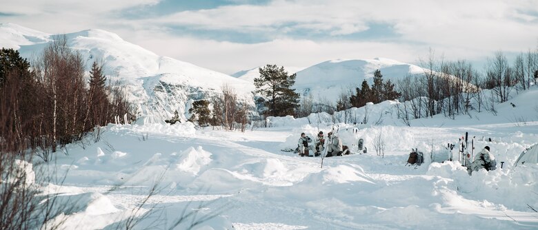 U.S. Marines with II Marine Expeditionary Force and a Norwegian soldier sit in a training area prior to Exercise Cold Response 2022, Setermoen, Norway, Feb. 24, 2022. Exercise Cold Response '22 is a biennial Norwegian national readiness and defense exercise that takes place across Norway, with participation from each of its military services, as well as from 26 additional North Atlantic Treaty Organization (NATO) allied nations and regional partners. (U.S. Marine Corps photo by Lance Cpl. Jacqueline C. Arre)