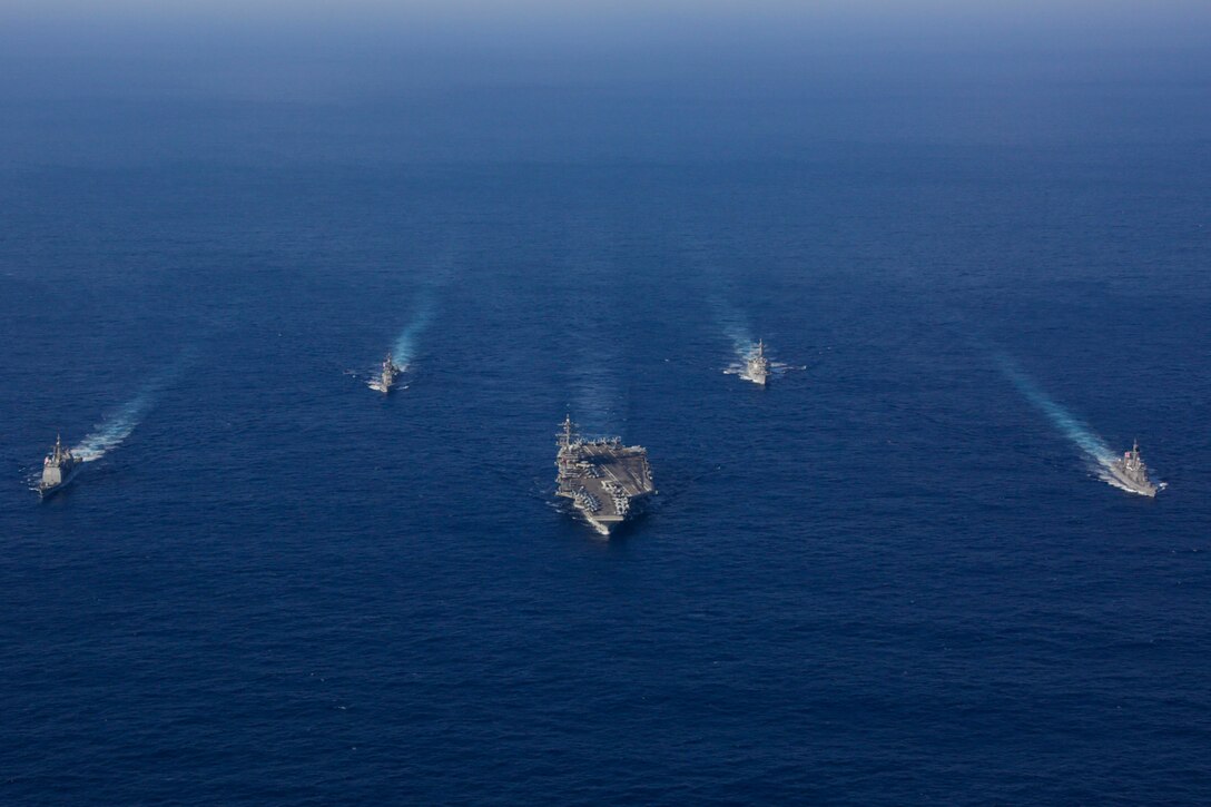 Five ships sail in formation.