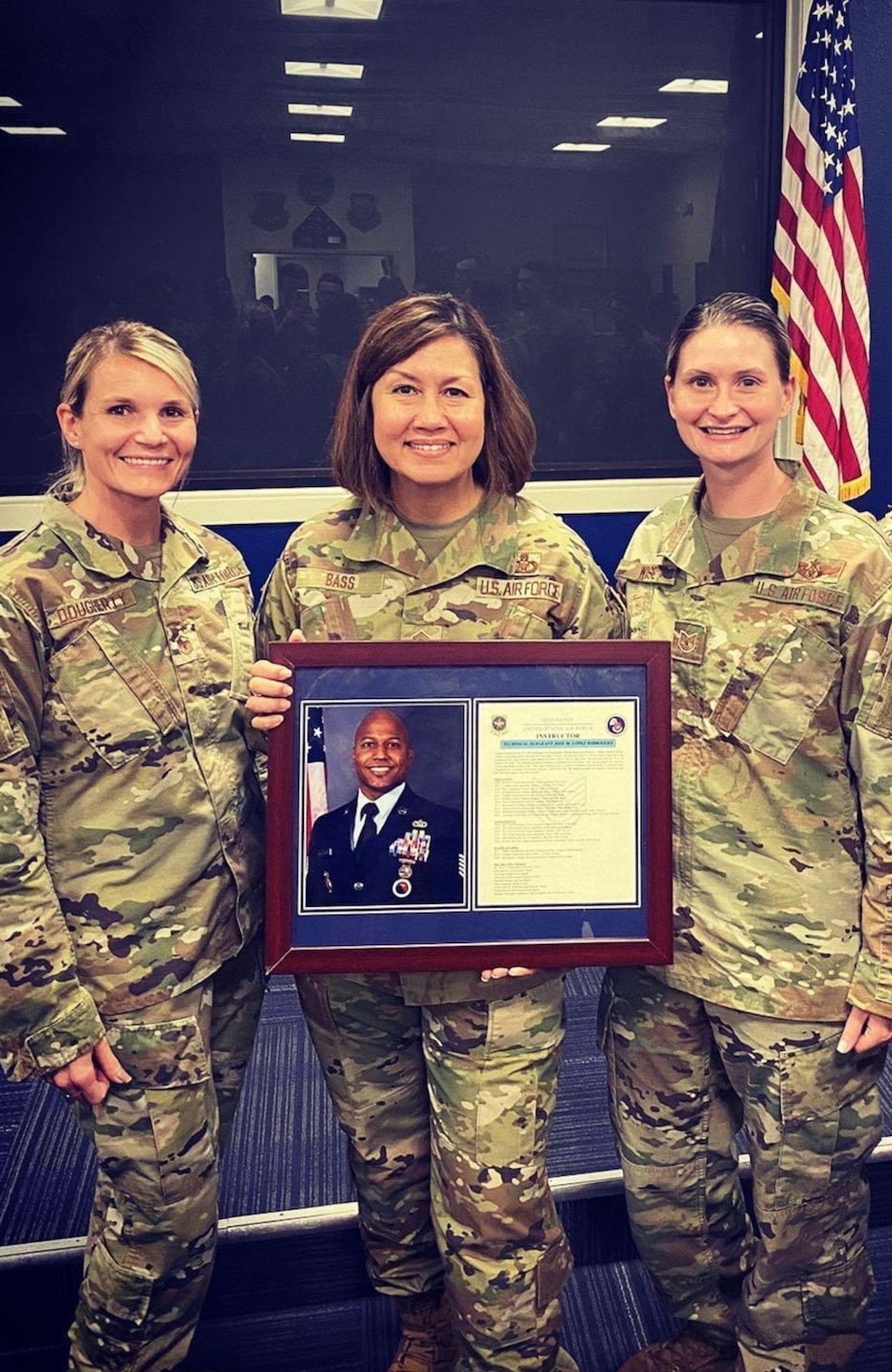 Chief Master Sgt. of the Air Force Joanne Bass, middle, poses for a photo with U.S. Air Force Master Sgt. Samantha Dougherty, MacDill Airman Leadership School (ALS) commandant, left, and U.S. Air Force Tech. Sgt. Shawna Wise, an instructor at the MacDill ALS, right, while holding a picture and biography of Tech Sgt. Jose Rodriguez, an instructor at the MacDill ALS, June 11, 2021, at MacDill Air Force Base, Florida. Chief Bass visited the MacDill ALS to see the dedicated work the school puts into developing tomorrow’s leaders. (Courtesy Photograph from MacDill ALS)