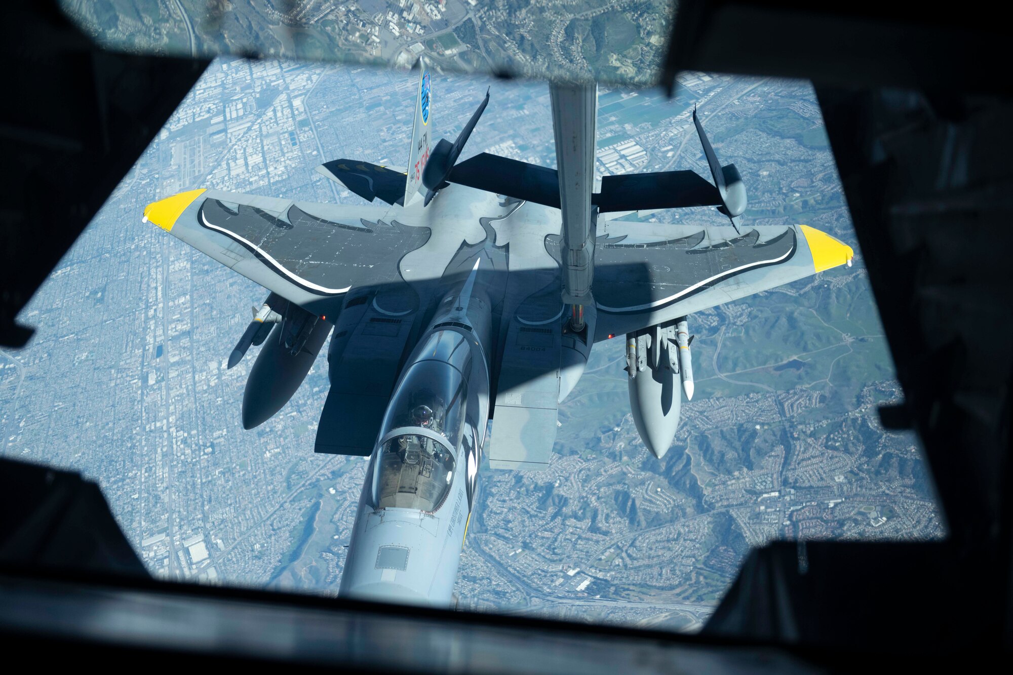 An F-15E Strike Eagle assigned to the 144th Fighter Wing approaches a KC-10 Extender