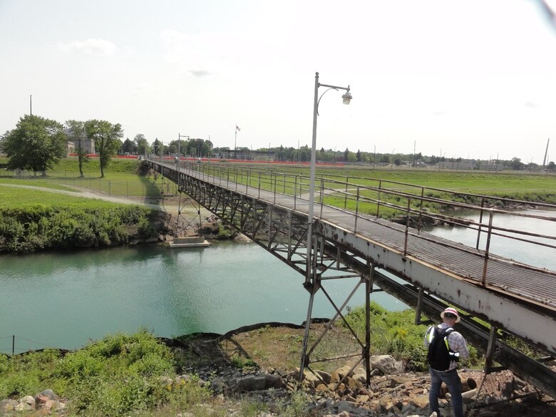 Detroit District Bridge Inspector Jacob Carr inspecting the columns and bearings at the north abutment of the Main Powerhouse Utility Bridge at the U.S. Army Corps of Engineers’ Soo Area Office in Sault Ste. Marie, Michigan in August 2021. This bridge will be replaced with a multi-span precast concrete girder bridge that will be located to the east of the existing bridge (left side in photo). U.S. Army Corps of Engineers photo by Andy Wadysz.