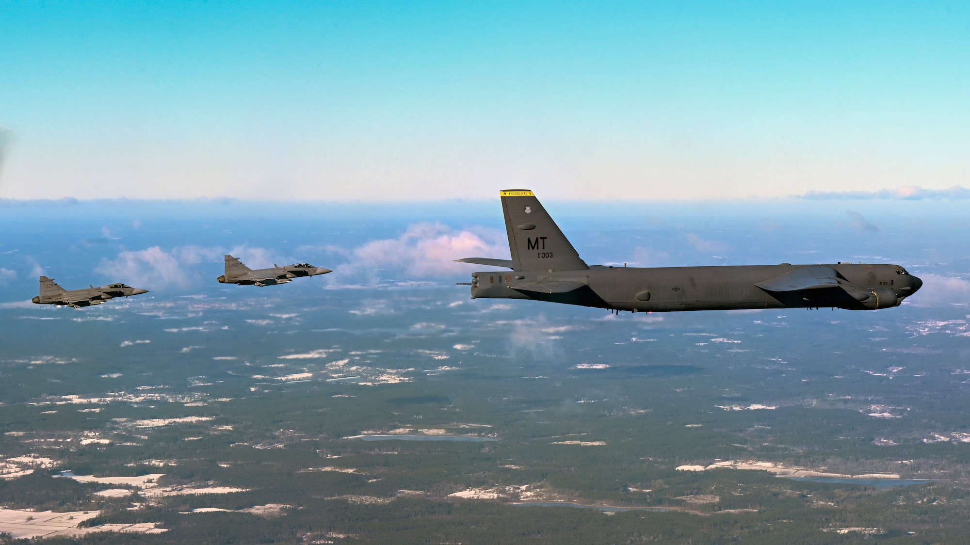 A B-52H Stratofortress from the 69th Expeditionary Bomb Squadron at RAF Fairford, United Kingdom is escorted by two Swedish Saab JAS 39 Gripens