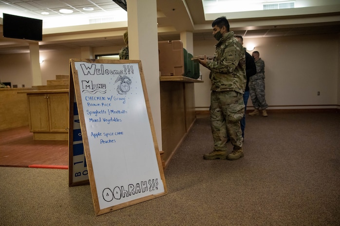 U.S. Marine Corps food service Marines with 2nd Landing Support Battalion, serve food to U.S. Army soldiers participating in Arctic Edge 22, in the Aurora Event Center on Eielson Air Force Base, Fairbanks, Alaska, Feb. 21, 2022. 2nd LSB provides a critical support role during exercise Arctic Edge 22, by supplying food services for all soldiers participating in the cold weather training. (Marine Corps photo taken by Lance Cpl. Jessica J. Mazzamuto)