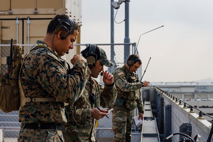 U.S. Marine Staff Sgt. Joshua Wilson, front, a joint terminal attack controller instructor with 5th Air Naval Gunfire Liaison Company, III Marine Expeditionary Force Information Group, and U.S. Army Special Forces operators with 1st Special Forces Group, conduct simulated close air support using handheld Link 16 radios at Marine Corps Air Station Iwakuni, Japan, Feb. 15, 2022. The training focused on the joint force’s ability to integrate and refine tactics of CAS, which requires detailed planning and careful coordination between pilots and forces on the ground.
