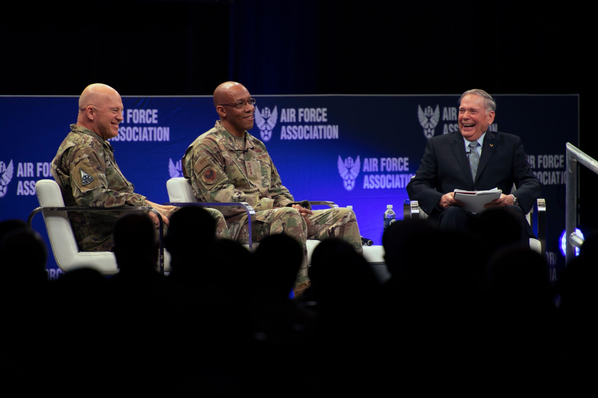 Chief of Space Operations Gen. John W. “Jay” Raymond, left, and Air Force Chief of Staff Gen. CQ Brown, Jr., center, speak at a fireside chat during the Air Force Association’s Air Warfare Symposium