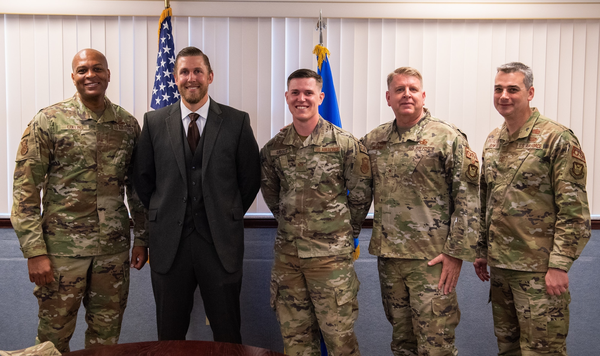 Special Agent Michael Robinette and Staff Sgt. Phillip Sibold, second and third from left, were lauded at Patrick Space Force Base, Florida, March 2, 2022, by Brig. Gen. Terry L. Bullard, OSI commander, second from right, Brig. Gen. Roy W. Collins, director of Security Forces and deputy chief of staff for Logistics, Engineering and Force Protection, left, and Chief Master Sgt. Gregg Gow, OSI command chief, right. The leaders commended the OSI teammates for their lifesaving actions during a domestic violence incident November, 2021. (Department of the Air Force photo by Amanda Inman, 45SW/PA-BMM)
