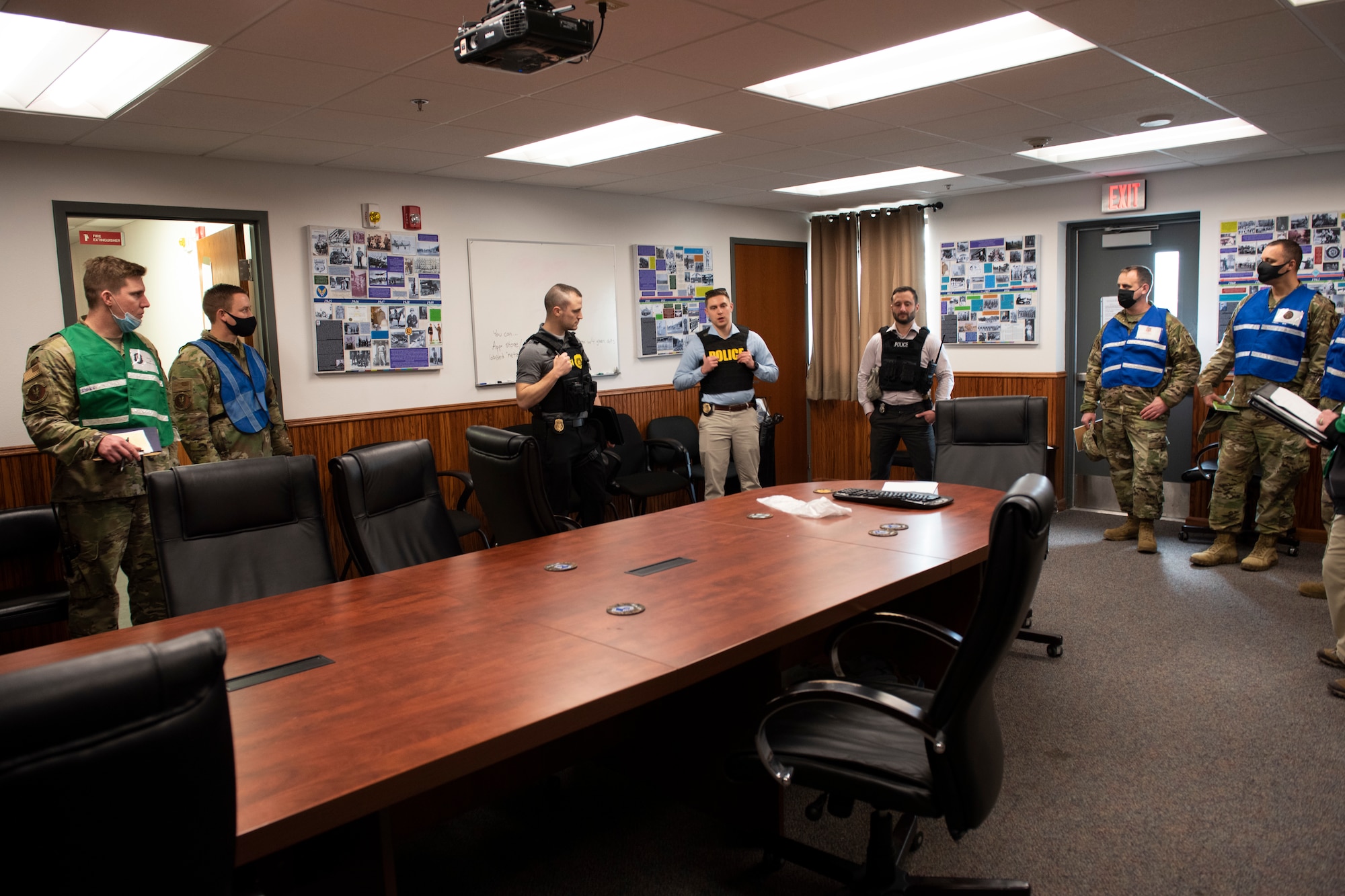 Three members of the Office of Special Investigations speak with Wing  Inspectors on how they would inspect a crime scene.