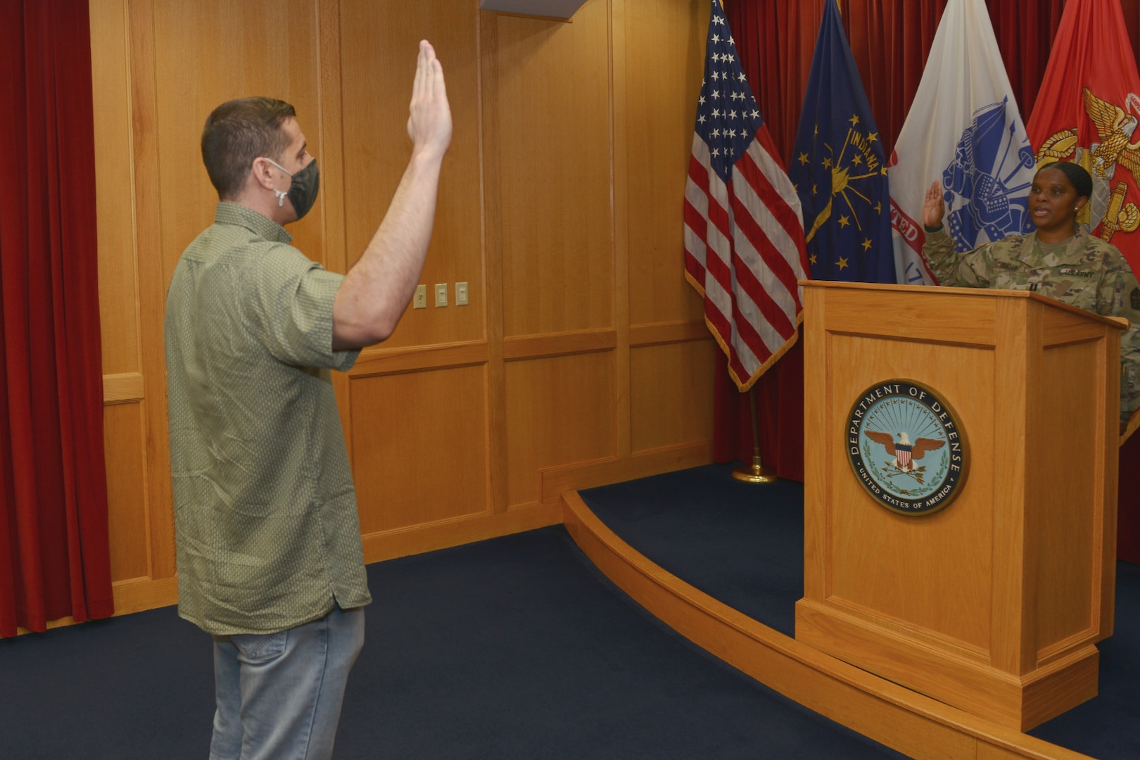 Recruit Mohammad Zaki Ahmadi swears into the Indiana National Guard as U.S. Army Capt. Aissata Diallo administers the oath of enlistment in Indianapolis March 3, 2022. Ahmadi was one of approximately 7,000 Afghan evacuees who filtered through Camp Atterbury as part of Operation Allies Welcome.