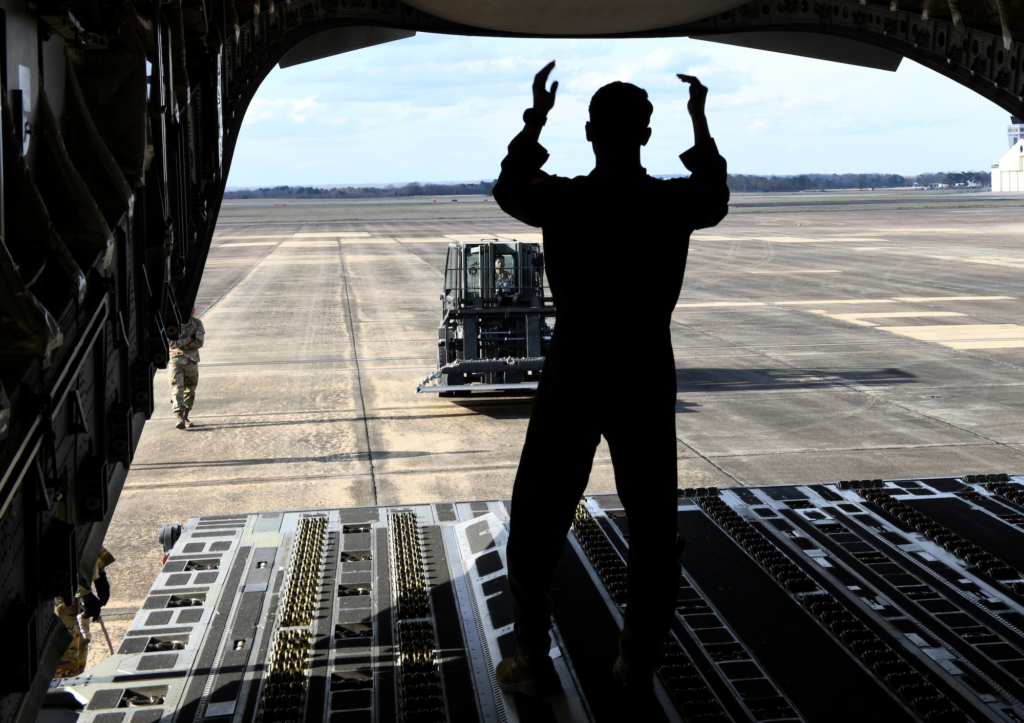 A C-130 aircrew member performs loading demo Feb 16, 2022 at Maxwell Air Force Base, Al. Air University’s Innovation Center and MGMWERX partnered with the 187th Fighter Wing and the 908th airlift wing to provide Auburn University students with a C-130 loading demo and C-17 static. (U.S. Air Force photo by Senior Airman Rhonda Smith)